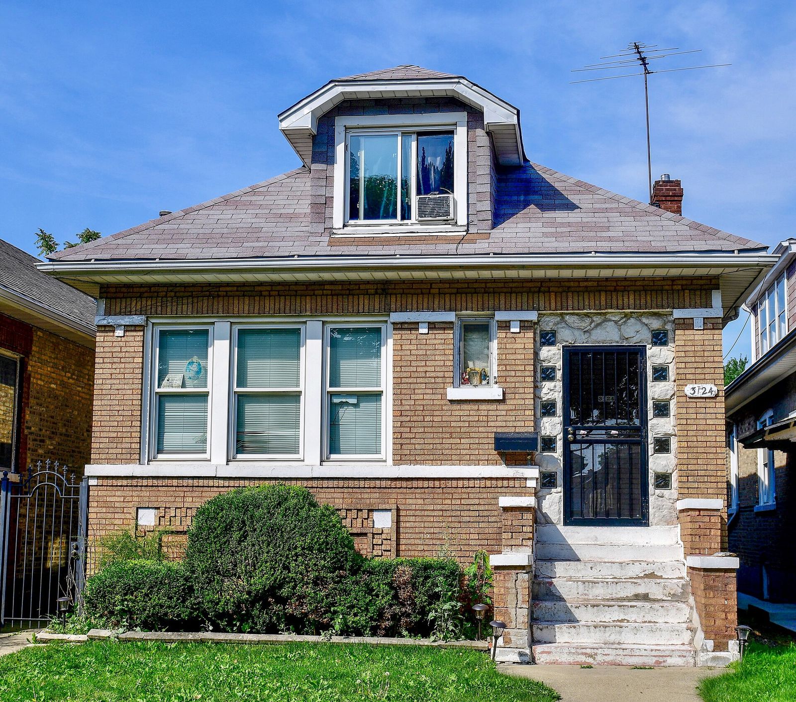 Chicago brick bungalow with a hipped roof and a front dormer